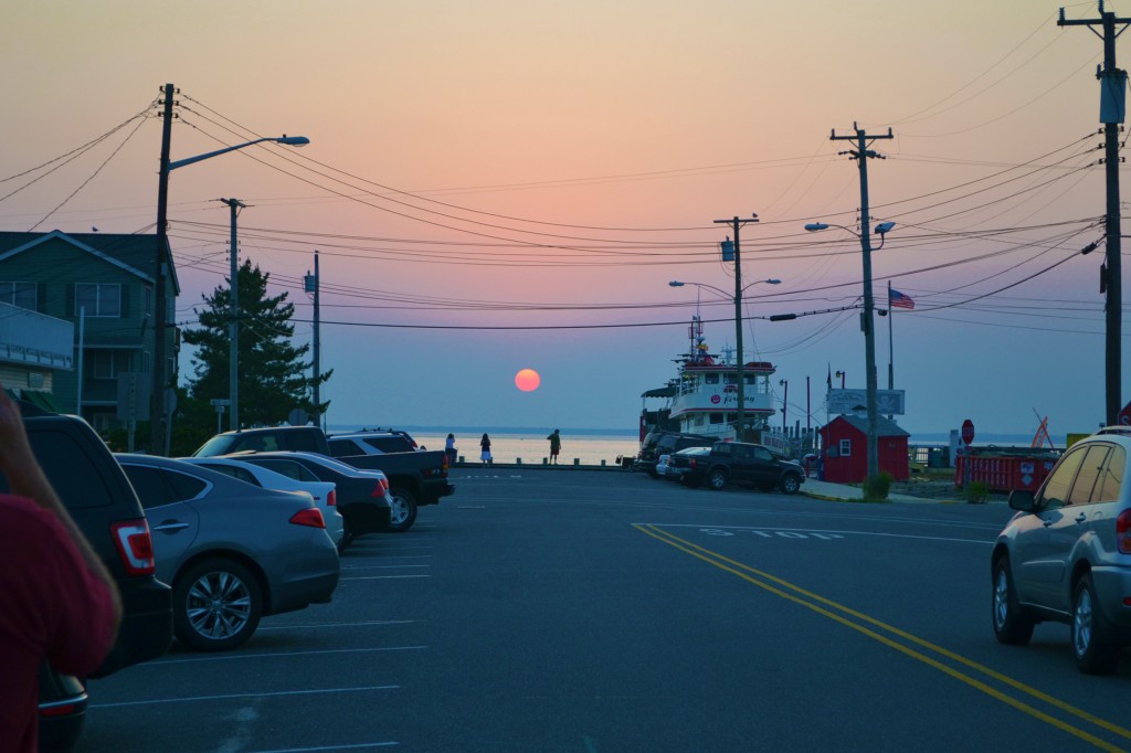 sunset over the bay looking down a street