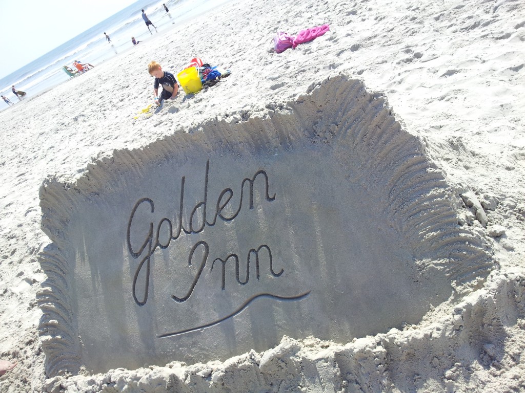 golden logo out of sand